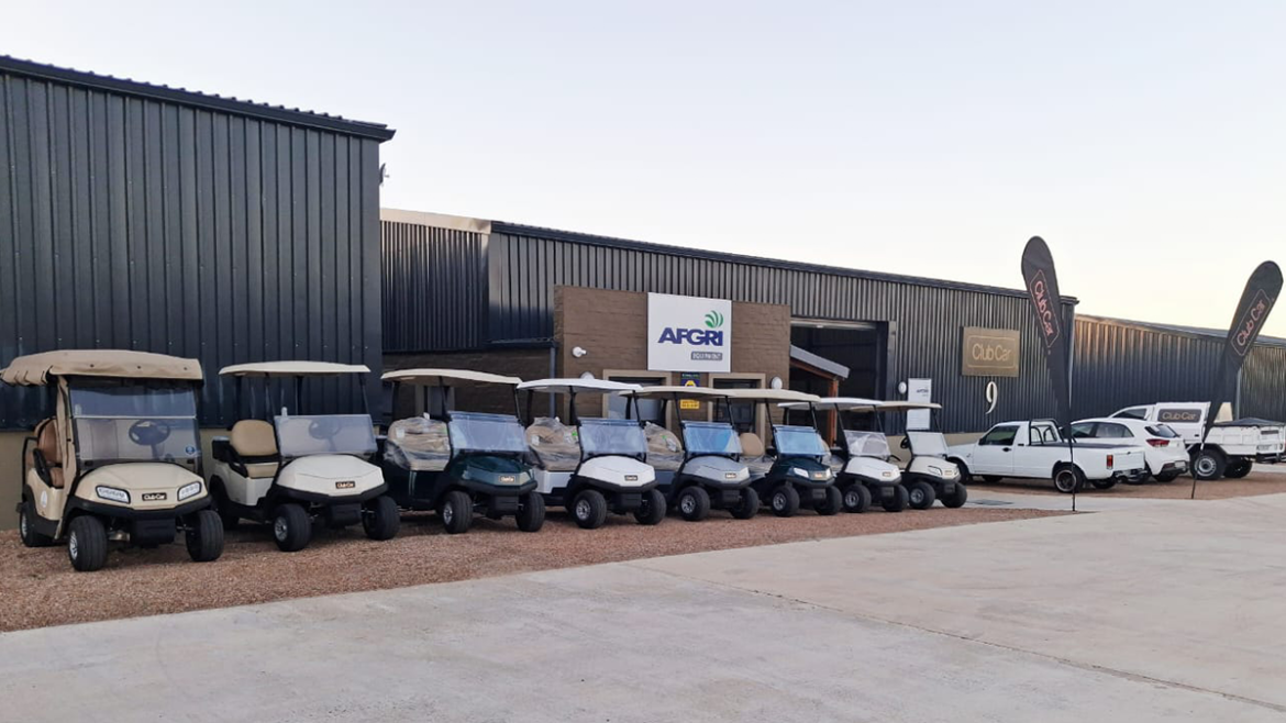 A photo of the Club Car - AFGRI Equipment George branch with a fleet of Club Cars parked outside the branch with two Club Car banners up outside. There are also AFGRI Equipment bakkies in the photos.