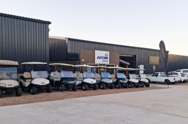 A photo of the Club Car - AFGRI Equipment George branch with a fleet of Club Cars parked outside the branch with two Club Car banners up outside. There are also AFGRI Equipment bakkies in the photos.