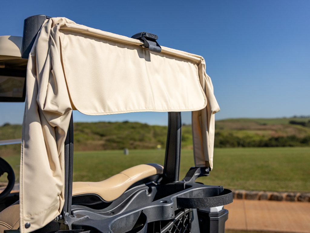 A Club Car Bag Protector on a blue Club Car Tempo that is folded away for easy access to the club.