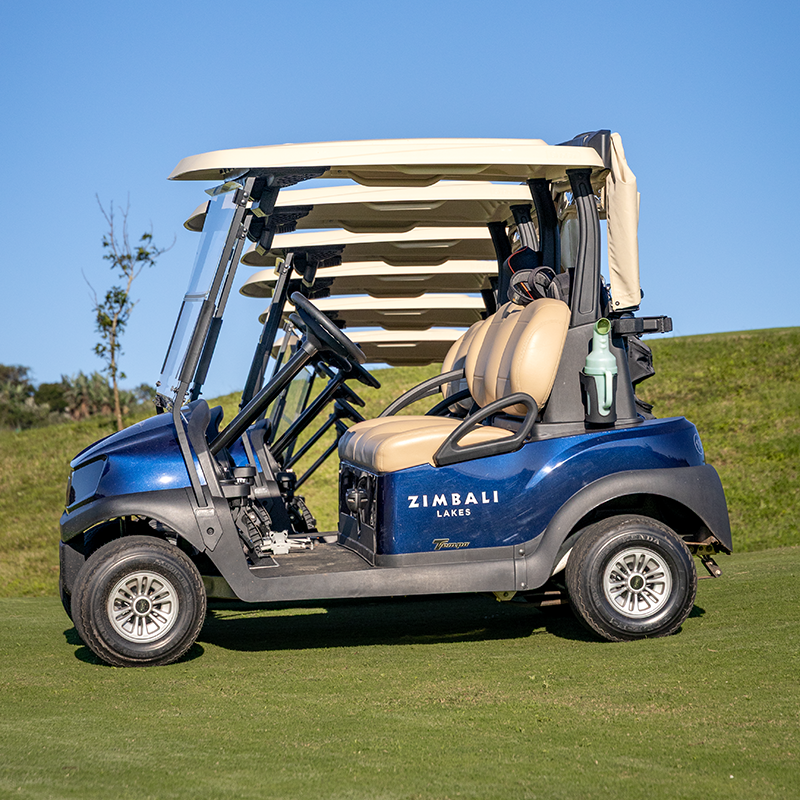 A fleet of Club Car Tempo 2's standing in a row behind each other on the Zimbali Lakes golf course.