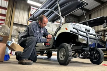 A Club Car golf cart being serviced
