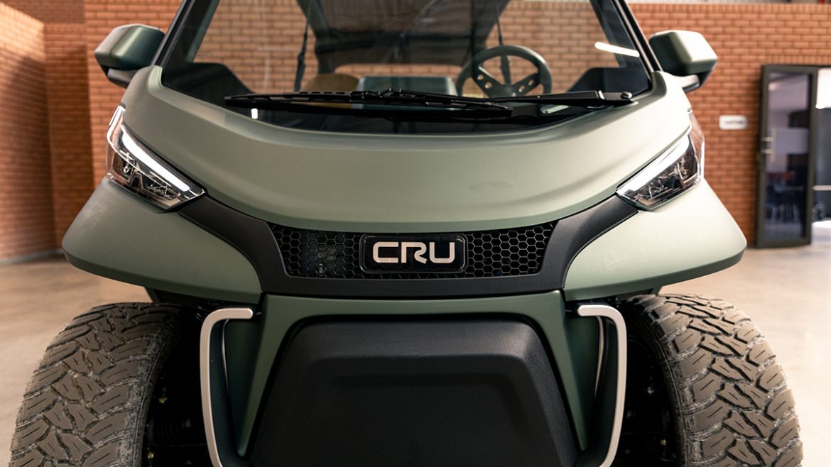 A photo of the front of a Club Car CRU. The wheels and headlights are visible.