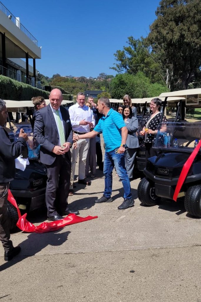 Ribbon Cutting at Houghton for new Club Car fleet and handshakes