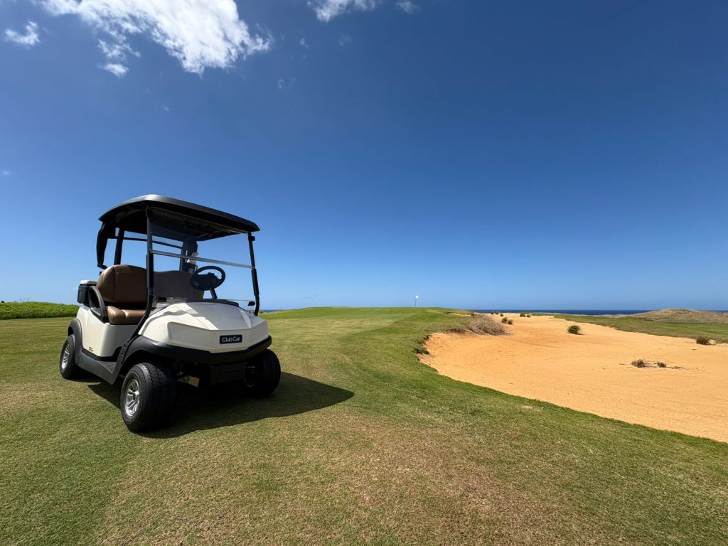 Club Car Tempo 2 Lithium golf cart parked on a fairway next to a sand pit at la Réserve, Mauritius