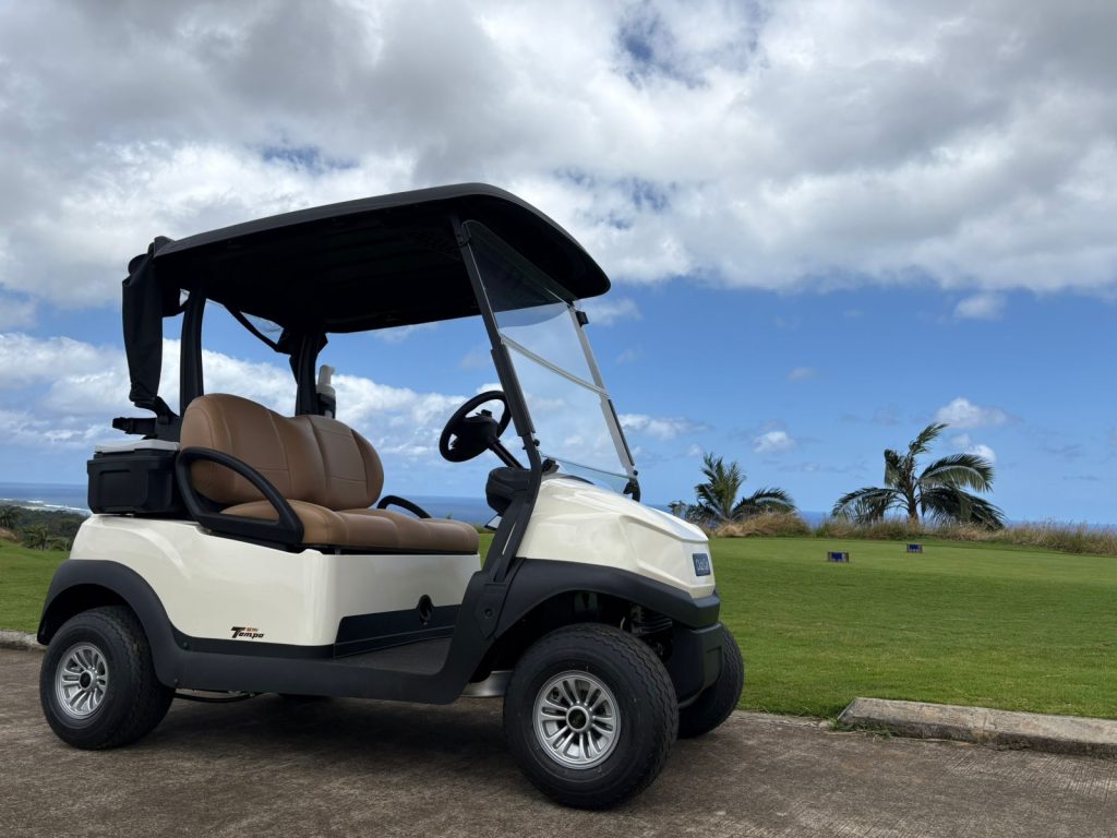 Club Car lithium golf cart on a lush fairway with palm trees in the background at La Réserve