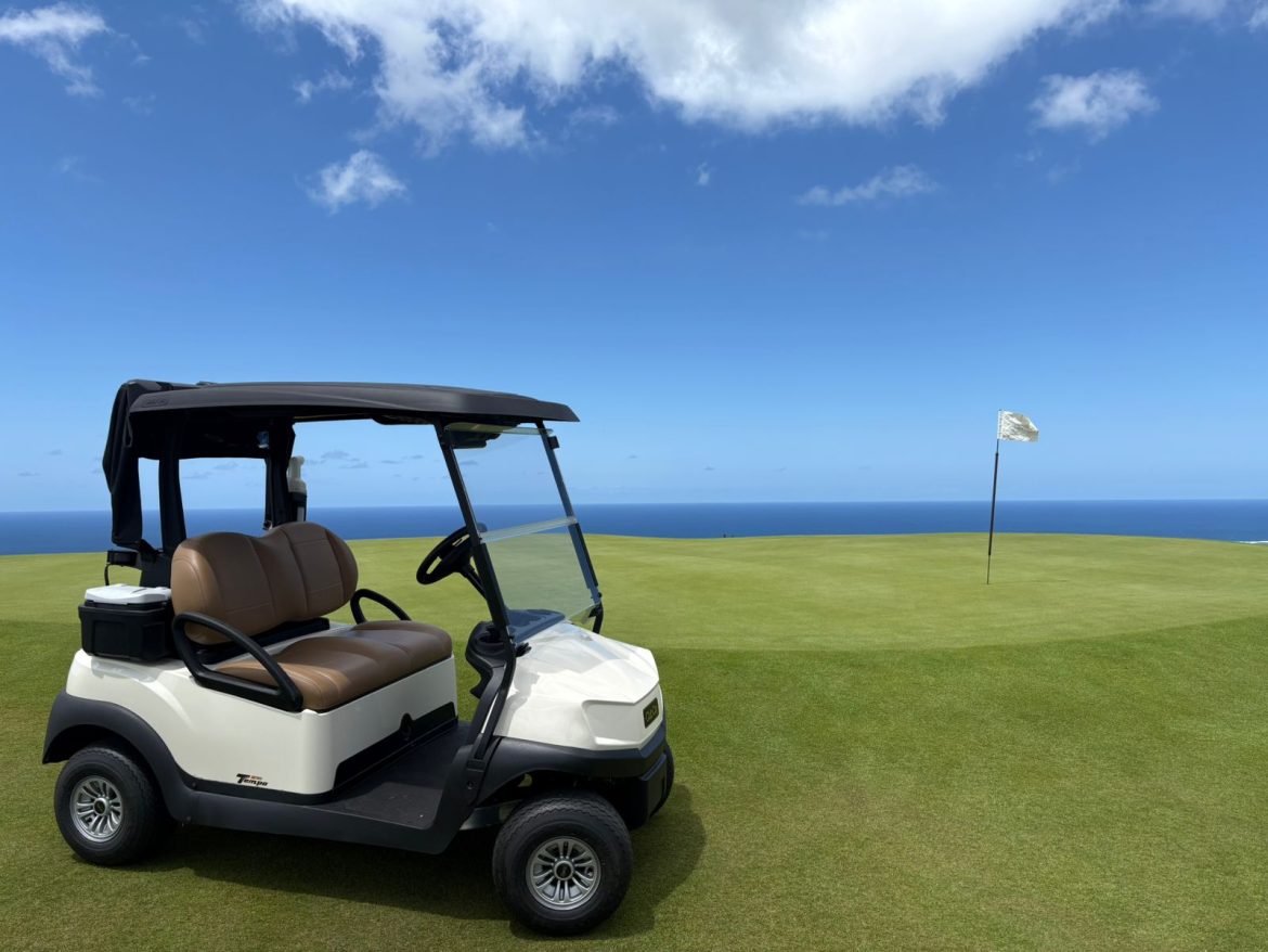 Club Car Tempo 2 Lithium golf cart parked on a fairway with ocean backdrop at La Réserve in Mauritius